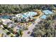 Aerial view of a community featuring a pool, clubhouse, tennis courts, and lush landscaping at 20308 Oak Key Ct, Tampa, FL 33647