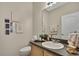 Bright bathroom featuring a vanity with a sink, a mirror, and neutral decor at 20308 Oak Key Ct, Tampa, FL 33647