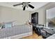 Cozy bedroom featuring neutral paint, ceiling fan, and wood floors at 20308 Oak Key Ct, Tampa, FL 33647