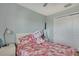 Cozy bedroom with ceiling fan and bright pink floral bedding at 20308 Oak Key Ct, Tampa, FL 33647
