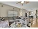 Bright living room features a ceiling fan, modern decor, and seamless access to other living areas at 20308 Oak Key Ct, Tampa, FL 33647