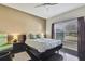 This main bedroom features a ceiling fan, a large window, and dark wood floors at 20308 Oak Key Ct, Tampa, FL 33647