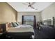 Relaxing main bedroom with dark wood floors, large window, and a dresser with TV at 20308 Oak Key Ct, Tampa, FL 33647
