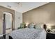 Cozy main bedroom with plush bedding, modern lamps, and view to a doorway leading to bathroom at 20308 Oak Key Ct, Tampa, FL 33647