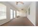 Sunroom with carpet flooring, ceiling fan, and sliding glass doors at 1522 Belle Glade Ave, Sun City Center, FL 33573