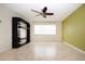 Living room featuring built-in shelving and a ceiling fan at 1522 Belle Glade Ave, Sun City Center, FL 33573