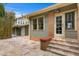 Back patio with stone tile flooring and stairs leading to a door at 261 7Th N Ave, St Petersburg, FL 33701