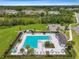 L-shaped community pool with plenty of lounge chairs at 1333 White Fox Run, Lutz, FL 33549