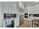 Modern kitchen with white cabinets, stainless steel appliances, and wine cooler at 1305 Apollo Beach Blvd, Apollo Beach, FL 33572