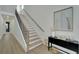 Modern staircase with black railings and light wood steps at 1305 Apollo Beach Blvd, Apollo Beach, FL 33572