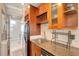 Modern kitchen with wood cabinets and granite countertops at 201 6Th S St # 106, St Petersburg, FL 33701