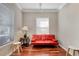 Bright living room with red couch and hardwood floors at 201 6Th S St # 106, St Petersburg, FL 33701