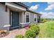 Inviting front entry with a dark green door, brick pavers, and well-maintained landscaping at 3125 Francoa Dr, Odessa, FL 33556