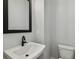 Modern bathroom with white sink, black faucet, and rectangular mirror at 6605 N Nebraska Ave # 3, Tampa, FL 33604