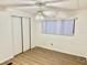 Bright bedroom with wood-look flooring, ceiling fan, and window coverings at 9790 66Th N St # 196, Pinellas Park, FL 33782