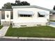 Charming mobile home with a landscaped yard and walkway at 9790 66Th N St # 196, Pinellas Park, FL 33782