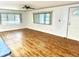 Living room with wood-look floors, neutral walls and ceiling fan at 9790 66Th N St # 196, Pinellas Park, FL 33782