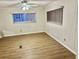 Simple bedroom with wood-look floors and window coverings at 9790 66Th N St # 196, Pinellas Park, FL 33782