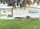 Home's exterior with covered patio, landscaping, and AC unit at 9790 66Th N St # 196, Pinellas Park, FL 33782