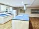 Modern kitchen with island, white cabinets, and blue countertops at 9790 66Th N St # 196, Pinellas Park, FL 33782