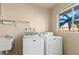 Laundry room with washer, dryer, and utility sink at 2001 Greenbriar Blvd # 5, Clearwater, FL 33763