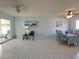 Combined living and dining area with tile floors and access to patio at 2001 Greenbriar Blvd # 5, Clearwater, FL 33763