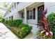 Townhome exterior with landscaping and black shutters at 34846 Teeview Ln, Zephyrhills, FL 33541