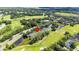 Aerial view showing home's location near golf course and pond at 34846 Teeview Ln, Zephyrhills, FL 33541