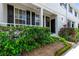 Townhome entrance with landscaping and black shutters at 34846 Teeview Ln, Zephyrhills, FL 33541