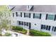 Two-story townhome with gray exterior, black shutters, and landscaping at 34846 Teeview Ln, Zephyrhills, FL 33541