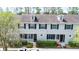 Three-unit townhome building with gray exterior and black shutters at 34846 Teeview Ln, Zephyrhills, FL 33541