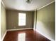 Second bedroom with hardwood floors and large window at 17889 Thomas Blvd, Hudson, FL 34667