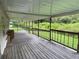 Long back porch with wooden railings and backyard view at 17889 Thomas Blvd, Hudson, FL 34667