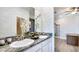 Double vanity bathroom with granite countertop and modern fixtures at 4302 Pullet Ct, Lakewood Ranch, FL 34211