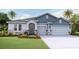 Two-story home with blue siding, stone accents, and a two-car garage at 4302 Pullet Ct, Lakewood Ranch, FL 34211