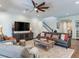 Bright living room with comfortable seating and staircase view at 31982 Bourneville Ter, Wesley Chapel, FL 33543