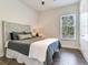 Bedroom with plush bedding and an ornate headboard at 31982 Bourneville Ter, Wesley Chapel, FL 33543
