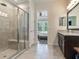 Bathroom with walk-in shower, double vanity, and view of bedroom at 31982 Bourneville Ter, Wesley Chapel, FL 33543