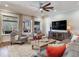 Spacious living room with comfortable seating, large TV, and view to backyard at 31982 Bourneville Ter, Wesley Chapel, FL 33543