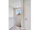 Upstairs hallway with a small window and carpet at 31982 Bourneville Ter, Wesley Chapel, FL 33543