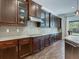 Spacious kitchen featuring dark wood cabinetry and granite countertops at 31982 Bourneville Ter, Wesley Chapel, FL 33543