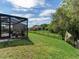 Spacious backyard, screened patio, and distant view of the house at 31982 Bourneville Ter, Wesley Chapel, FL 33543