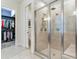 Large bathroom with walk-in shower and access to walk-in closet at 31982 Bourneville Ter, Wesley Chapel, FL 33543