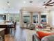 Open concept living room and kitchen with large windows at 31982 Bourneville Ter, Wesley Chapel, FL 33543