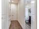 Hallway with tile flooring and access to multiple rooms at 31982 Bourneville Ter, Wesley Chapel, FL 33543