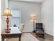 Home office with hardwood floors, large desk and comfortable armchair at 31982 Bourneville Ter, Wesley Chapel, FL 33543