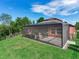 Screened patio and spacious backyard with lush landscaping at 31982 Bourneville Ter, Wesley Chapel, FL 33543