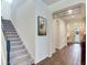 Bright entryway with tile flooring, staircase, and decorative accents at 31982 Bourneville Ter, Wesley Chapel, FL 33543