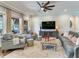 Relaxing living room featuring comfortable seating and a large TV at 31982 Bourneville Ter, Wesley Chapel, FL 33543