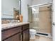 Bathroom boasts granite countertop, dark wood cabinets, and a large shower at 31982 Bourneville Ter, Wesley Chapel, FL 33543